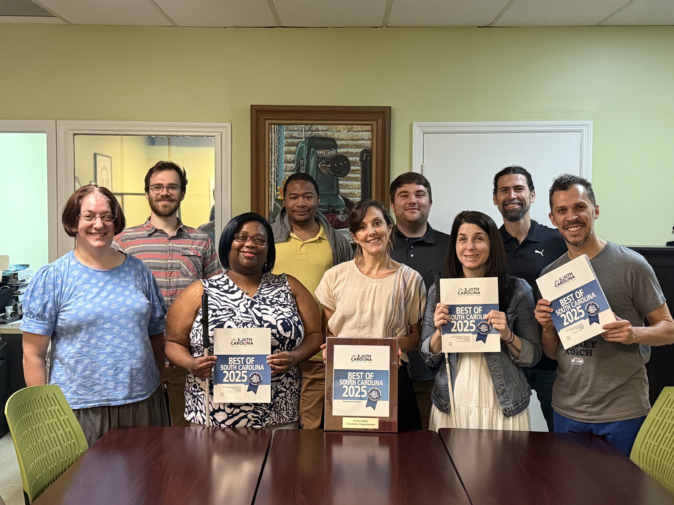 The AccessAbility team and community members together, holding AccessAbility signs.