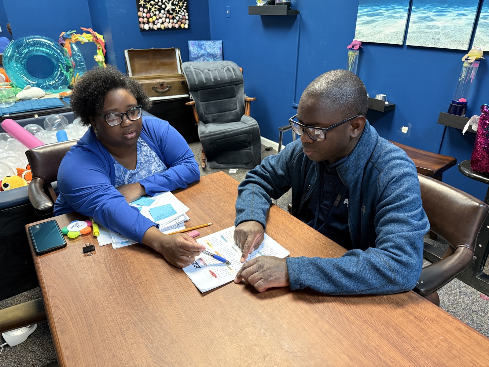 An AccessAbility specialist working one-on-one with a member on independent-living skills.