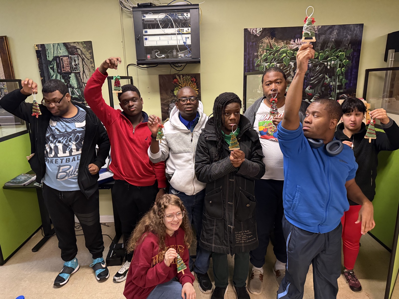 Leadership Initiative Team members holding handmade ornaments they crafted together.