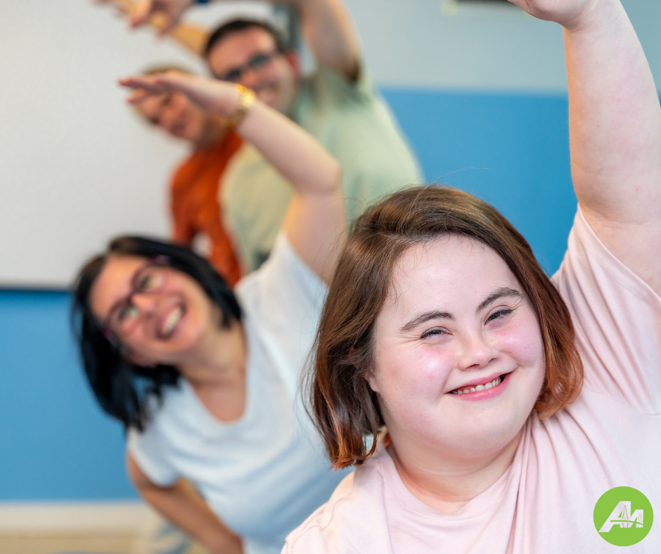 A group of young adults exercising in a group workout class.