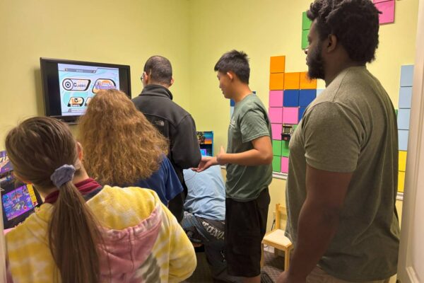 LIT members in the video game room playing games at Scotty's Place.
