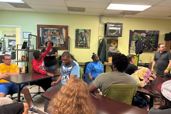 LIT members sitting and listening to a lesson given by LaChan from AccessAbility.