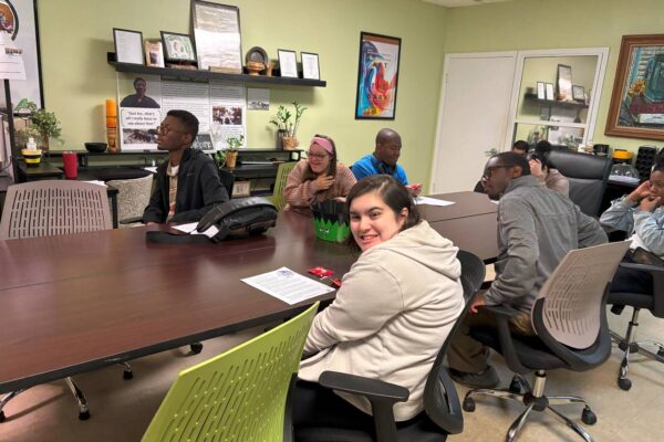 LIT members sitting and listening to a lesson given by James from AccessAbility.