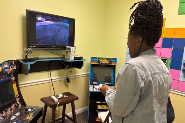 A LIT member playing a video game at Scotty's Place.