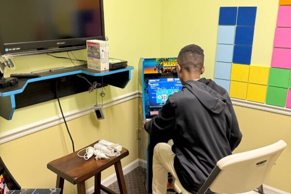 A LIT member playing a video game at Scotty's Place.
