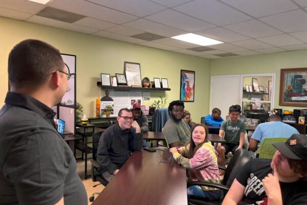 LIT members sitting and listening to a lesson given by James from AccessAbility.
