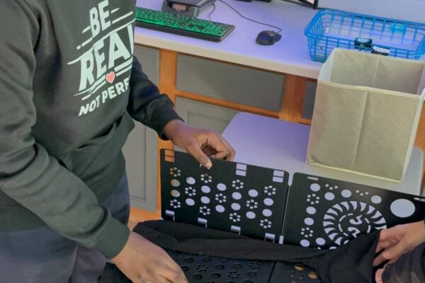 A student is packaging clothing on Big Benny.