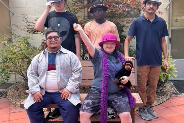 Summer session attendees posing in the sensory garden for a group photo.