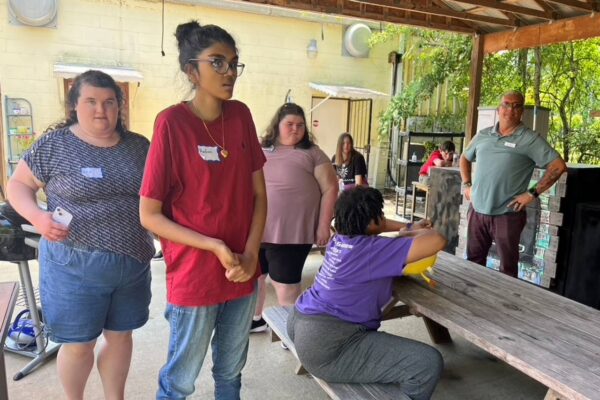 Summer Session attendees hanging out at the picnic tables.