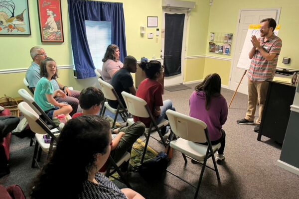 J from AccessAbility teaching summer session attendees about advocacy.